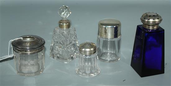 5 silver topped bottles, including a hair tidy